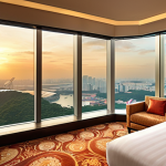 **

Prompt: Luxurious hotel room, high floor, panoramic city view, sunrise, Marina Bay Sands, Singapore, warm colors, modern interior, large windows, early morning light.

**